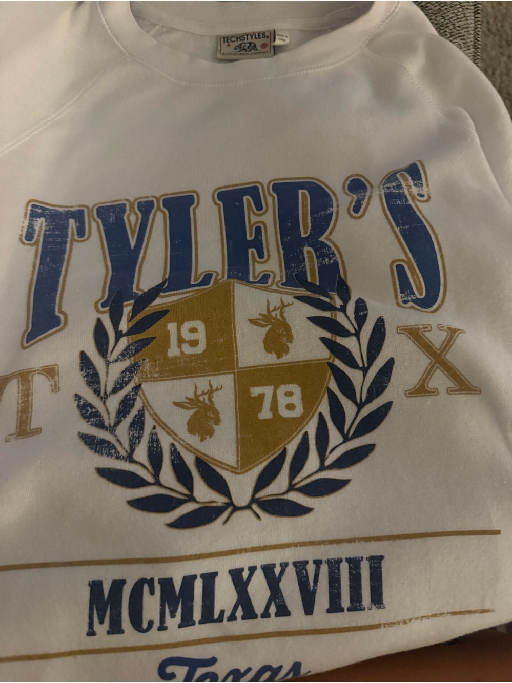 Tyler's White Graphic Sweatshirt with Blue & Gold Crest